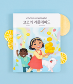 Load image into Gallery viewer, A Korean bilingual children's book titled 'Coco's Lemonade' with Korean Hangul, featuring colorful illustrations of a girl, a dog, and a friend. The title shows text in Korean and English.
