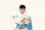 Load image into Gallery viewer, Child reading Mandarin bilingual children's book titled 'Coco's Lemonade' featuring colorful illustrations of a girl, a dog, and a friend. The title shows text in Mandarin Simplified Chinese and English.
