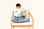 Load image into Gallery viewer, Child reading Mandarin bilingual children's book titled 'Coco's Lemonade' featuring colorful illustrations of a girl, a dog, and a friend. The title shows text in Mandarin Traditional Chinese and English.
