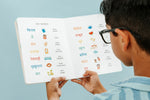Load image into Gallery viewer, Inside book page from the bilingual Hindi–English children’s book Pay It Forward, showing beginner everyday words vocabulary with Hindi Script and Transliteration and English text for early readers with Child holding the book and reading.
