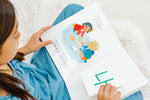 Load image into Gallery viewer, Inside lift‑the‑flap page from the bilingual Korean–English children’s book Pay It Forward showing Korean Hangul and English text for early readers.
