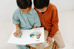 Load image into Gallery viewer, Two children (boys) holding the bilingual Mandarin Chinese English children’s book Pay It Forward, showing the colorful illustrations and Mandarin–English text.
